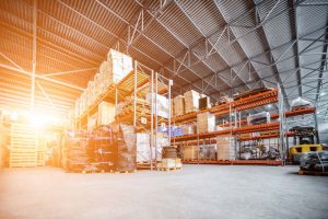 Large hangar warehouse industrial and logistics companies. Warehousing on the floor and called the high shelves. Toning the image.